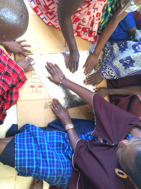 Many hands making solar ovens